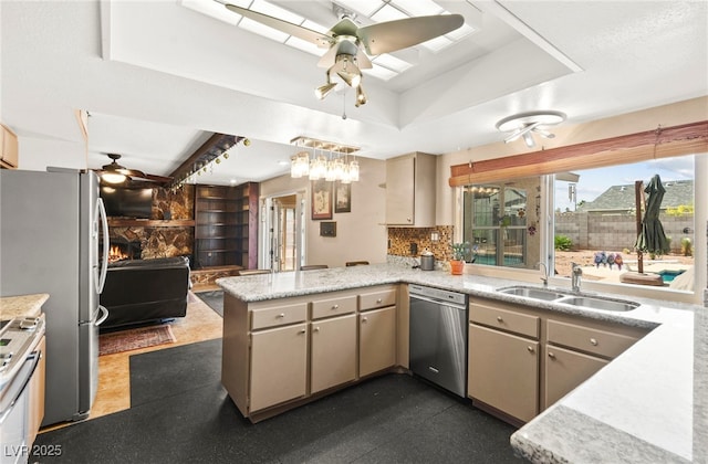 6612 Elton Ave, Las Vegas, NV 89107 - kitchen featuring ceiling fan, stainless steel appliances, a sink, a peninsula, and a raised ceiling