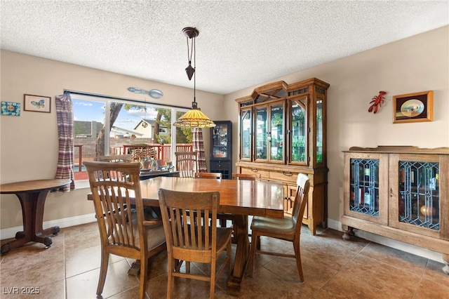 6612 Elton Ave, Las Vegas, NV 89107 - dining space featuring a textured ceiling, tile patterned floors, and baseboards