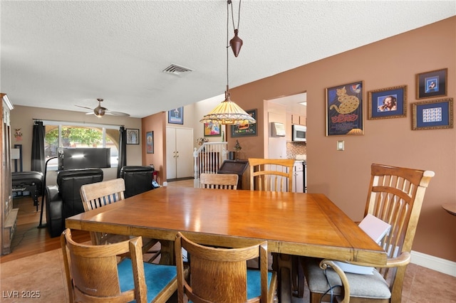 6612 Elton Ave, Las Vegas, NV 89107 - dining area featuring a ceiling fan, a textured ceiling, and baseboards