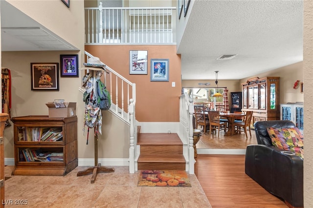 6612 Elton Ave, Las Vegas, NV 89107 - stairway featuring baseboards, tile patterned floors, and a textured ceiling