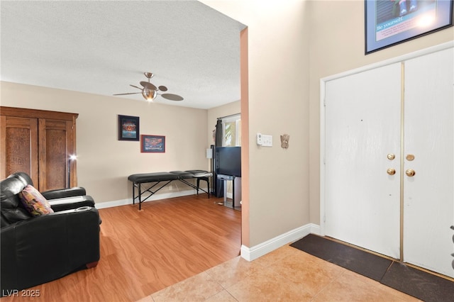6612 Elton Ave, Las Vegas, NV 89107 - foyer entrance with ceiling fan, baseboards, light tile patterned floors, and a textured ceiling