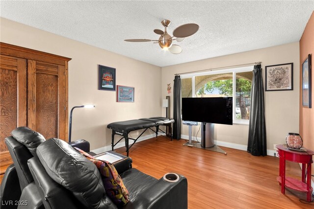 6612 Elton Ave, Las Vegas, NV 89107 - living area with a ceiling fan, light wood-style flooring, a textured ceiling, and baseboards