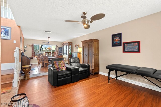 6612 Elton Ave, Las Vegas, NV 89107 - living area with light wood-style floors, a ceiling fan, and a textured ceiling