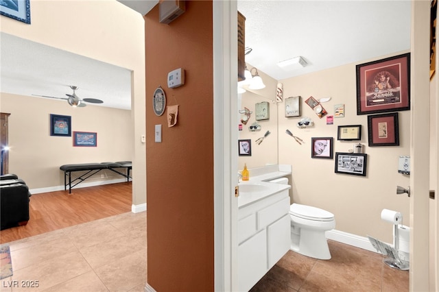 6612 Elton Ave, Las Vegas, NV 89107 - bathroom featuring vanity, toilet, ceiling fan, tile patterned floors, and baseboards