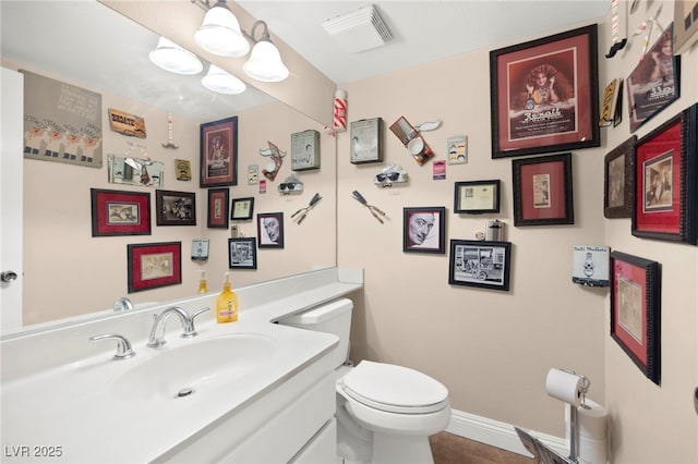 6612 Elton Ave, Las Vegas, NV 89107 - bathroom featuring toilet, vanity, baseboards, and tile patterned flooring