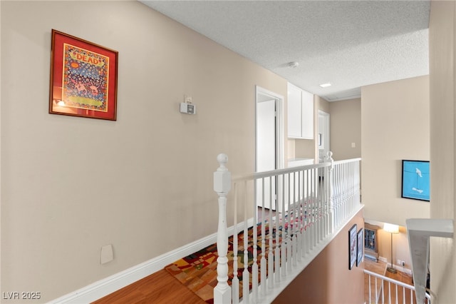 6612 Elton Ave, Las Vegas, NV 89107 - corridor featuring an upstairs landing, baseboards, wood finished floors, and a textured ceiling