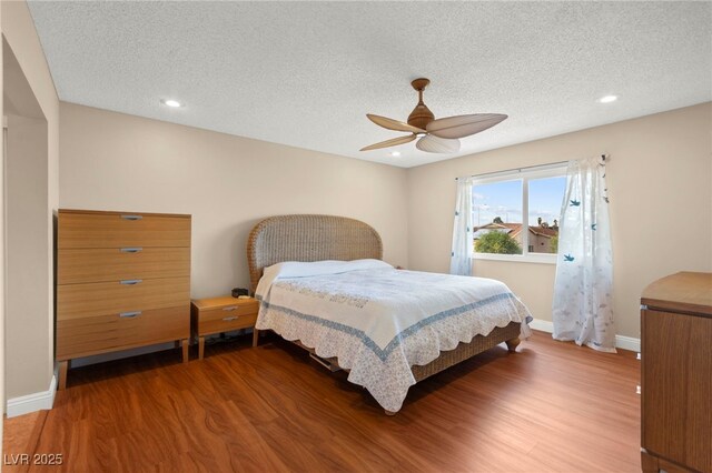 6612 Elton Ave, Las Vegas, NV 89107 - bedroom featuring wood finished floors, baseboards, a textured ceiling, a ceiling fan, and recessed lighting