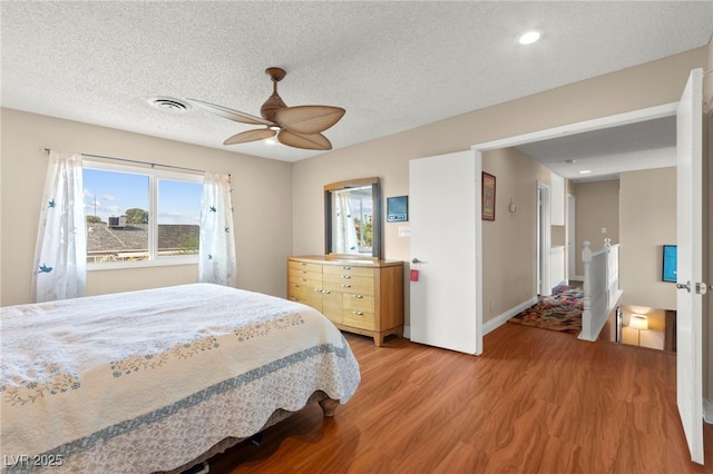 6612 Elton Ave, Las Vegas, NV 89107 - bedroom with light wood-type flooring, multiple windows, a ceiling fan, a textured ceiling, and recessed lighting
