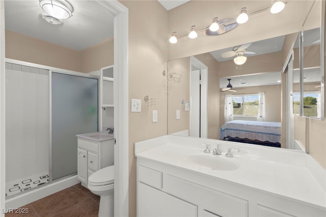 6612 Elton Ave, Las Vegas, NV 89107 - ensuite bathroom featuring a shower stall, vanity, tile patterned flooring, a ceiling fan, and toilet