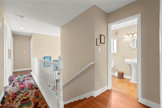 6612 Elton Ave, Las Vegas, NV 89107 - hallway featuring an upstairs landing, wood finished floors, and baseboards
