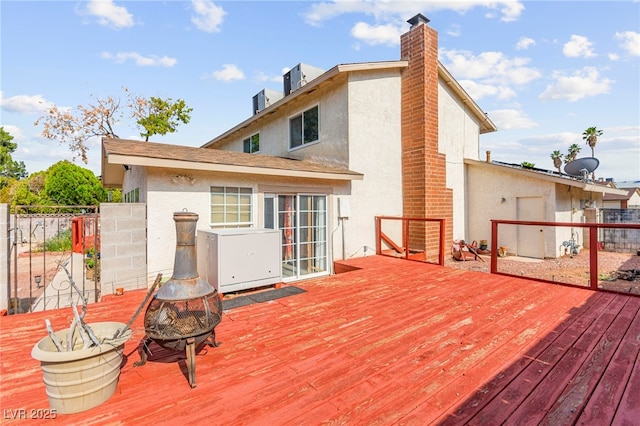 6612 Elton Ave, Las Vegas, NV 89107 - wooden deck with an outdoor fire pit