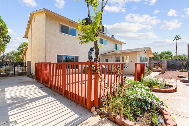 6612 Elton Ave, Las Vegas, NV 89107 - back of house featuring stucco siding, a deck, a gate, and central AC unit