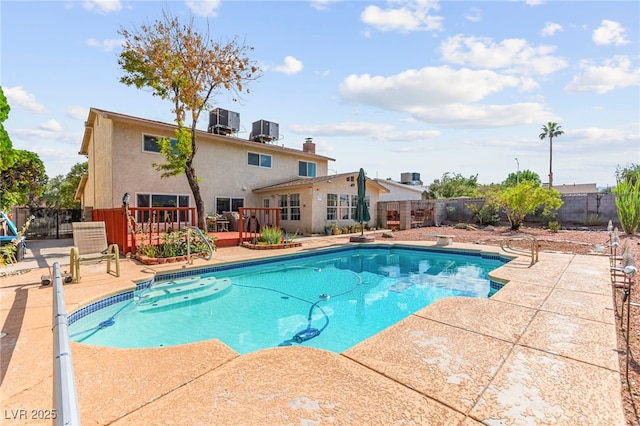 6612 Elton Ave, Las Vegas, NV 89107 - view of pool with a fenced backyard, a deck, central AC unit, and a patio area