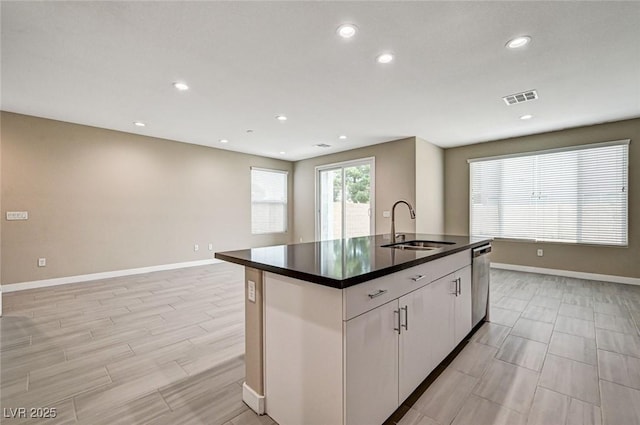 3760 Paseo De Paz Ave, Las Vegas, NV 89115 - kitchen with a sink, stainless steel dishwasher, dark countertops, baseboards, and recessed lighting