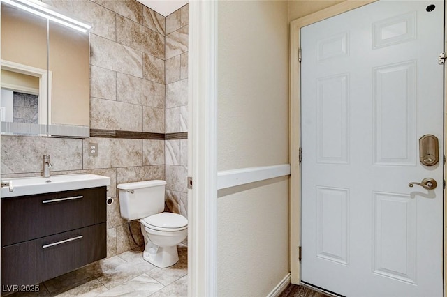 8113 Gothic Ave, Las Vegas, NV 89117 - bathroom featuring vanity, toilet, and tile walls