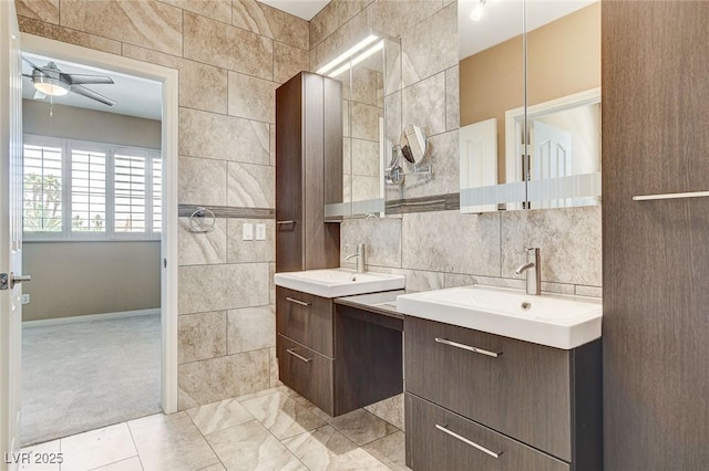 8113 Gothic Ave, Las Vegas, NV 89117 - full bath with tile walls, a ceiling fan, two vanities, and decorative backsplash