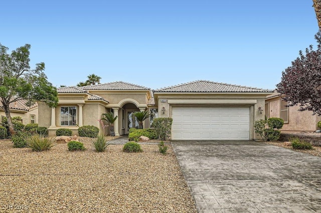 4311 Fiore Bella Blvd, Las Vegas, NV 89135 - mediterranean / spanish-style home featuring driveway, stucco siding, a garage, and a tiled roof