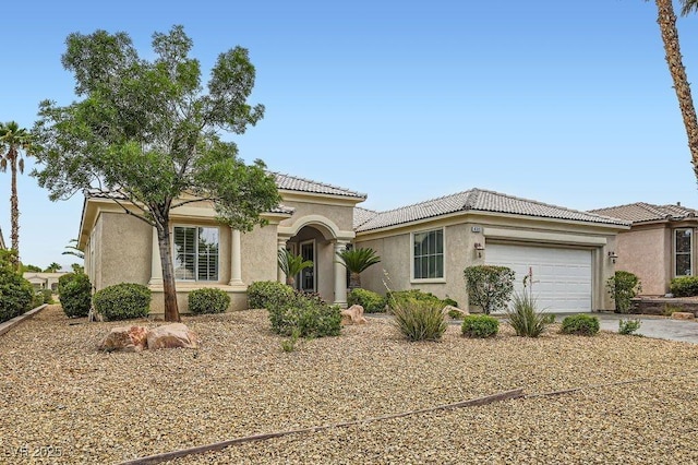 4311 Fiore Bella Blvd, Las Vegas, NV 89135 - view of front of property with stucco siding, a tiled roof, an attached garage, and driveway