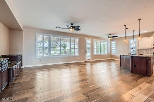 4311 Fiore Bella Blvd, Las Vegas, NV 89135 - unfurnished living room with a ceiling fan and light wood finished floors