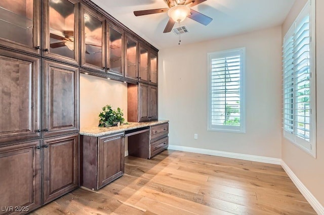 4311 Fiore Bella Blvd, Las Vegas, NV 89135 - unfurnished office featuring built in desk, light wood-style flooring, and ceiling fan