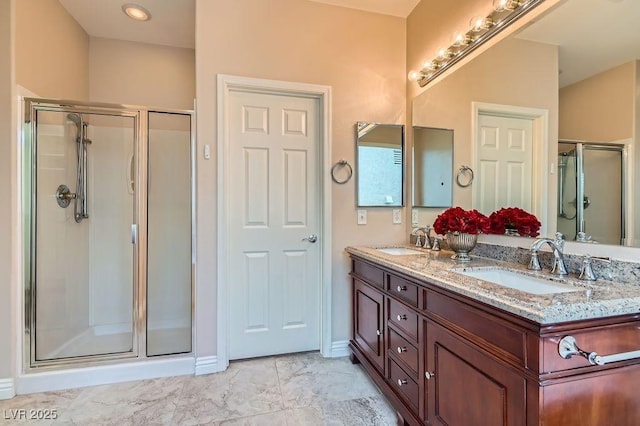4311 Fiore Bella Blvd, Las Vegas, NV 89135 - full bathroom featuring double vanity, a shower stall, and marble look tiles