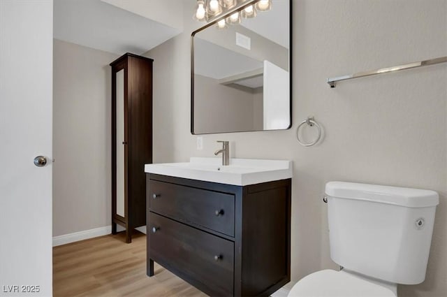 8070 W Russell Rd Unit 2052, Las Vegas, NV 89113 - bathroom with toilet, vanity, wood finished floors, and baseboards