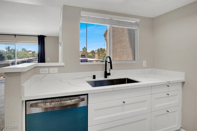 8070 W Russell Rd Unit 2052, Las Vegas, NV 89113 - kitchen featuring stainless steel dishwasher, a sink, white cabinetry, and light stone counters