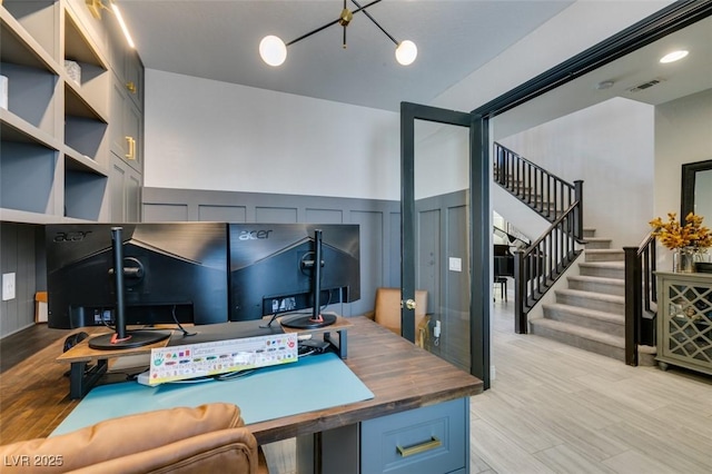 7194 Sage Wren Ct, Las Vegas, NV 89148 - home office with light wood-type flooring, a decorative wall, and a chandelier