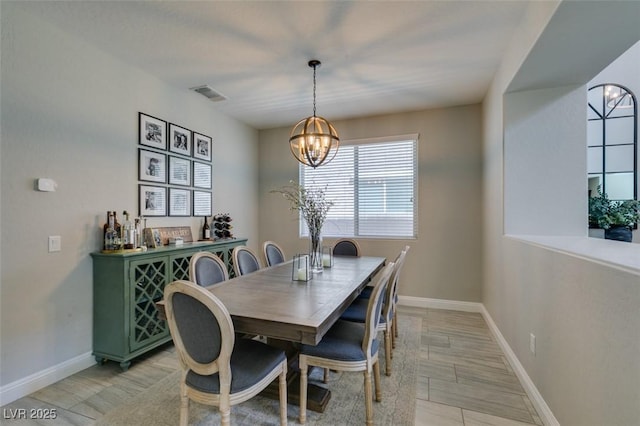 7194 Sage Wren Ct, Las Vegas, NV 89148 - dining area with a chandelier, baseboards, and light wood-type flooring