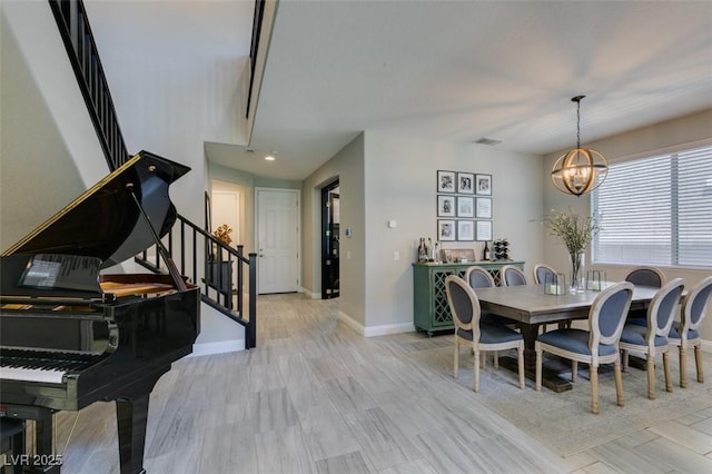 7194 Sage Wren Ct, Las Vegas, NV 89148 - dining area with a chandelier, stairway, baseboards, and light wood-style floors