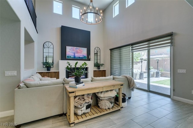 7194 Sage Wren Ct, Las Vegas, NV 89148 - living room with a towering ceiling, baseboards, and a chandelier