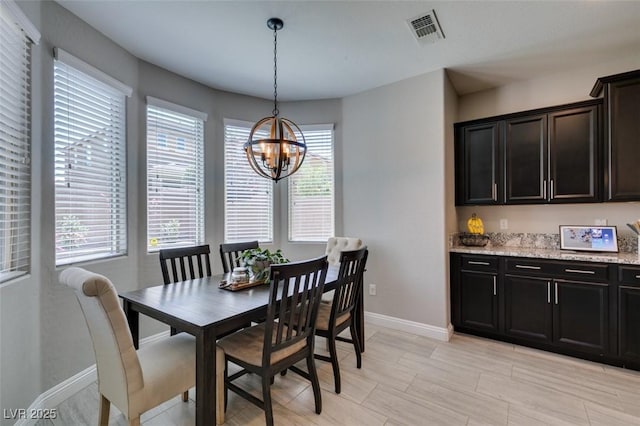 7194 Sage Wren Ct, Las Vegas, NV 89148 - dining area with a chandelier, healthy amount of natural light, and baseboards