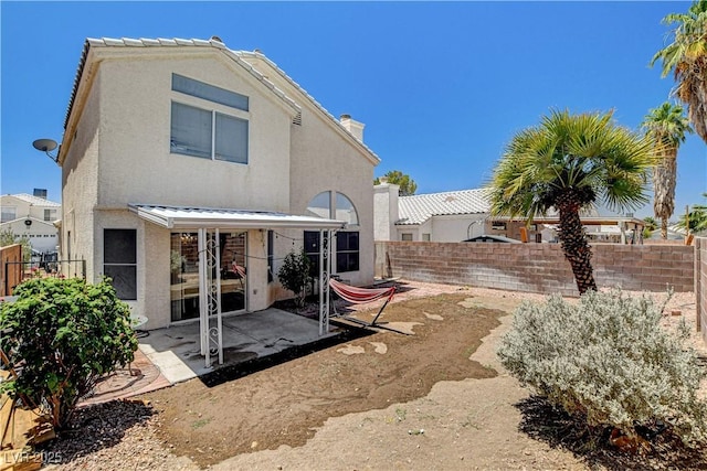 6058 Grape Blossom Ave, Las Vegas, NV 89142 - back of property featuring a patio area, stucco siding, and a fenced backyard