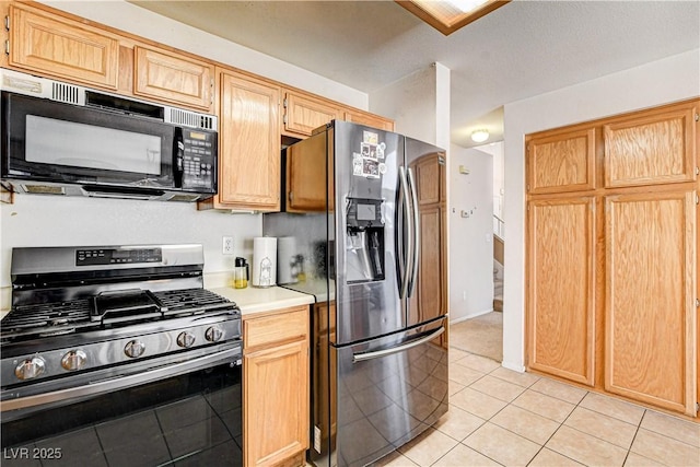 6058 Grape Blossom Ave, Las Vegas, NV 89142 - kitchen featuring stainless steel appliances, light countertops, light tile patterned floors, and light brown cabinetry