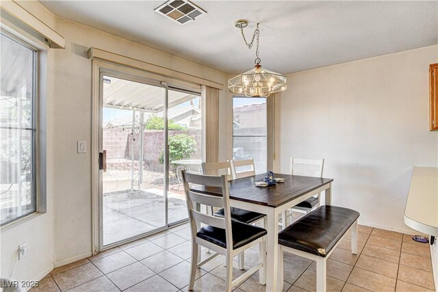 6058 Grape Blossom Ave, Las Vegas, NV 89142 - dining area with a chandelier and light tile patterned floors