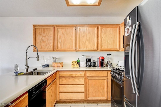 6058 Grape Blossom Ave, Las Vegas, NV 89142 - kitchen with black appliances, light brown cabinetry, light countertops, and light tile patterned floors
