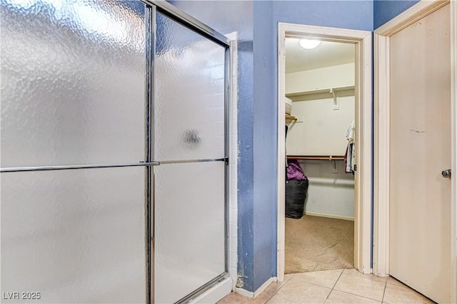 6058 Grape Blossom Ave, Las Vegas, NV 89142 - bathroom featuring a stall shower, tile patterned floors, and a walk in closet