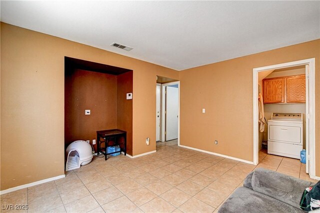 6058 Grape Blossom Ave, Las Vegas, NV 89142 - unfurnished living room featuring washer / dryer and light tile patterned flooring