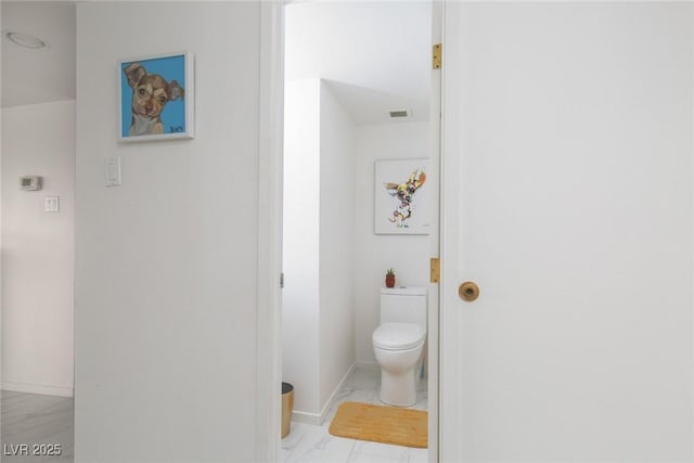 3111 Bel Air Dr Unit 12G, Las Vegas, NV 89109 - bathroom with toilet, marble look tiles, and baseboards