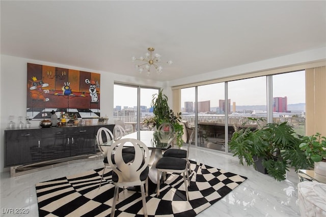 3111 Bel Air Dr Unit 12G, Las Vegas, NV 89109 - dining space with a view of city, a chandelier, and marble tiled flooring