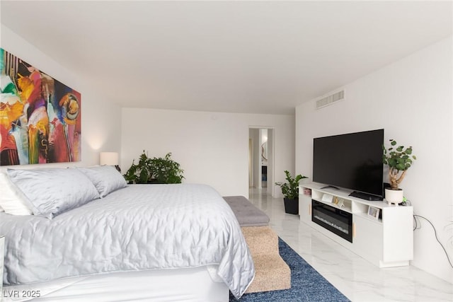 3111 Bel Air Dr Unit 12G, Las Vegas, NV 89109 - bedroom featuring light marble finish floors and a glass covered fireplace