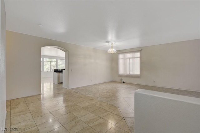 1408 Reebok Ter, Henderson, NV 89014 - spare room with plenty of natural light, arched walkways, and light tile patterned floors