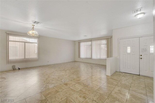 1408 Reebok Ter, Henderson, NV 89014 - entrance foyer with healthy amount of natural light, light tile patterned flooring, and a chandelier