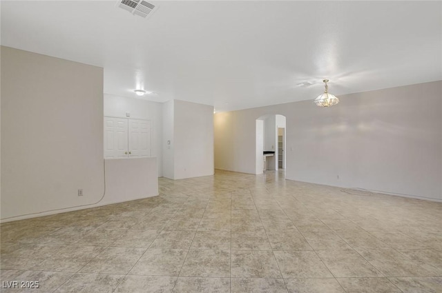 1408 Reebok Ter, Henderson, NV 89014 - unfurnished room featuring arched walkways, light tile patterned flooring, and a chandelier
