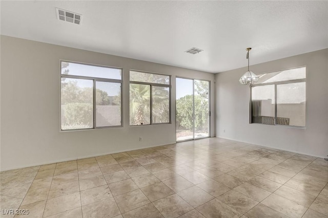 1408 Reebok Ter, Henderson, NV 89014 - tiled spare room featuring healthy amount of natural light and a chandelier