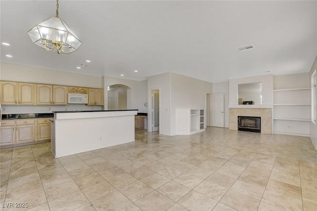 1408 Reebok Ter, Henderson, NV 89014 - kitchen featuring white microwave, light brown cabinets, arched walkways, a chandelier, and dark countertops