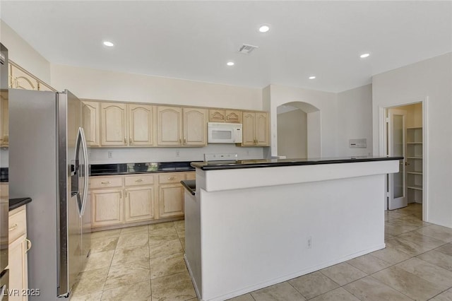 1408 Reebok Ter, Henderson, NV 89014 - kitchen with white microwave, stainless steel refrigerator with ice dispenser, light brown cabinets, dark countertops, and recessed lighting