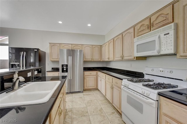 1408 Reebok Ter, Henderson, NV 89014 - kitchen with white appliances, light brown cabinets, a sink, dark countertops, and recessed lighting