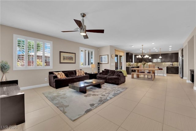 5542 Oak Bend Dr, Las Vegas, NV 89135 - living area with a chandelier, a ceiling fan, light tile patterned floors, and recessed lighting