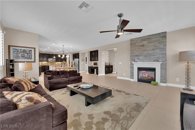 5542 Oak Bend Dr, Las Vegas, NV 89135 - living area featuring a ceiling fan, light tile patterned floors, a fireplace, recessed lighting, and a chandelier